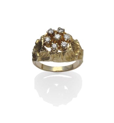 Lot 1063 - A Diamond Cluster Ring, seven round brilliant cut diamonds spaced in yellow claw settings over...