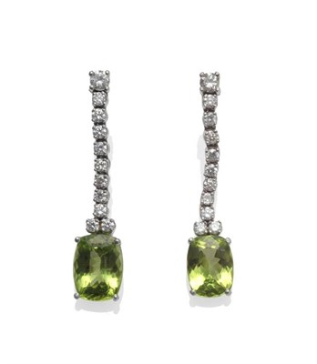 Lot 1068 - A Pair of 18 Carat White Gold Peridot and Diamond Drop Earrings, a string of round brilliant...