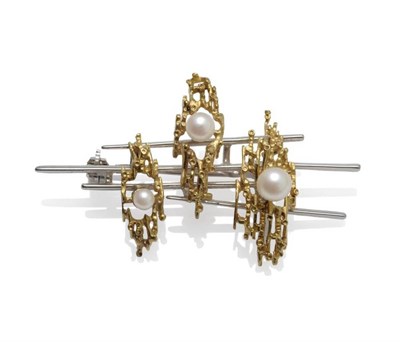 Lot 1069 - A Cultured Pearl Brooch, circa 1965, of asymmetric white bars, overlaid with three textured...