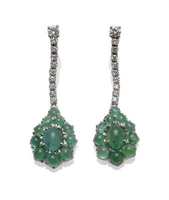 Lot 1070 - A Pair of 18 Carat White Gold Emerald and Diamond Drop Earrings, a row of round brilliant cut...