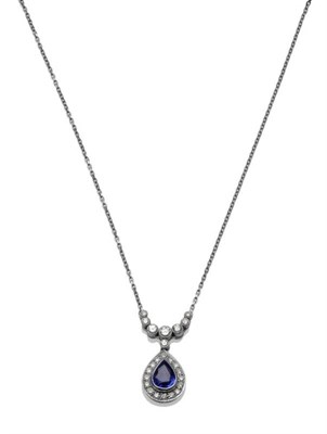 Lot 1073 - An 18 Carat White Gold Sapphire and Diamond Necklace, a pear cut sapphire within a border of...