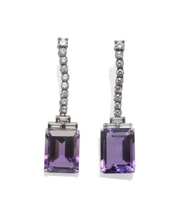 Lot 1077 - A Pair of 18 Carat White Gold Amethyst and Diamond Drop Earrings, a row of round brilliant cut...