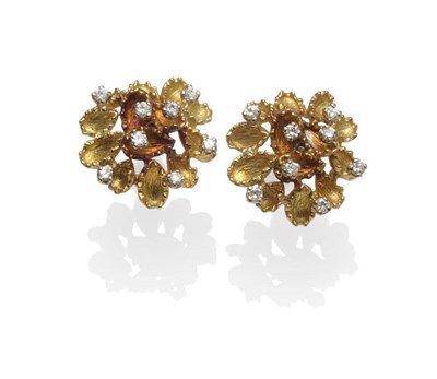 Lot 1082 - A Pair of Diamond Set Earrings, in a stylised floral form, with textured yellow petals, and...