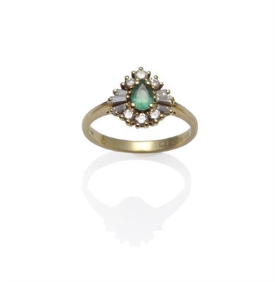 Lot 1087 - An 18 Carat Gold Emerald and Diamond Cluster Ring, the pear cut emerald within a border of...