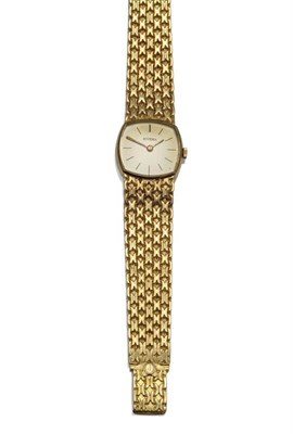 Lot 1107 - A Lady's 18ct Gold Wristwatch, signed Juvenia, circa 1965, lever movement, silvered dial with baton