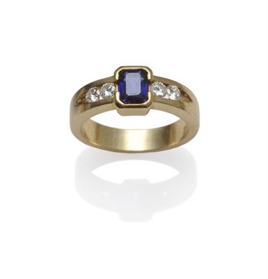 Lot 1113 - A Sapphire and Diamond Ring, a baguette cut sapphire in a yellow part collet setting, to...