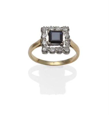 Lot 1114 - A Sapphire and Diamond Cluster Ring, the square step cut sapphire within a border of eight-cut...