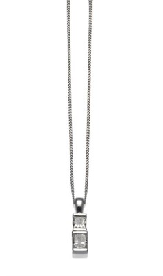 Lot 1145 - A Diamond Pendant on Chain, two princess cut diamonds in broad white claw settings, on a...