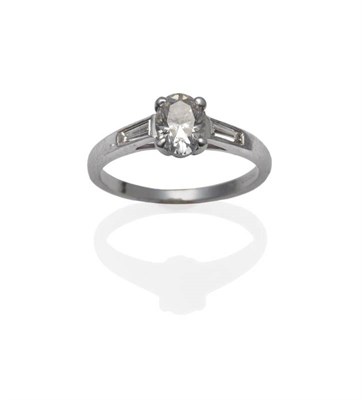 Lot 1150 - An 18 Carat White Gold Diamond Solitaire Ring, the oval cut diamond in claw settings to tapered...