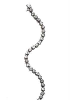 Lot 1153 - A 9 Carat White Gold Diamond Line Bracelet, the round brilliant cut diamonds in collet...