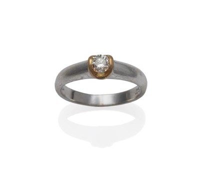 Lot 1157 - An 18 Carat White and Yellow Gold Diamond Solitaire Ring, the round brilliant cut diamond in a...