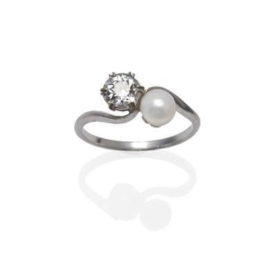 Lot 1158 - A Diamond and Cultured Pearl Two Stone Twist Ring, the old cut diamond and the cultured pearl...