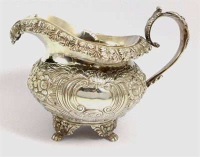 Lot 1196 - A Irish Silver Milk Jug, James Fray, Dublin 1826, the bulbous body and rim with embossed floral...