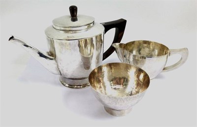 Lot 1263 - An Arts & Crafts Silvered Metal Tea Service, unmarked, comprising teapot, milk just and sugar bowl