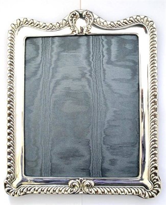 Lot 1017 - A Modern Silver Photograph Frame, maker's mark DR&S, London 1988, with an embossed frame, the...
