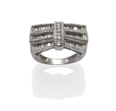 Lot 1097 - A Bow Shaped Ring, inset with baguette cut and brilliant cut diamonds, in channel settings,...