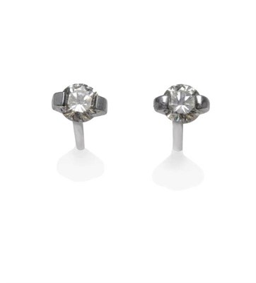 Lot 1100 - A Pair of 18 Carat White Gold Diamond Solitaire Stud Earrings, a round brilliant cut diamond in...