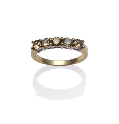 Lot 1112 - A 9 Carat Gold Diamond Five Stone Ring, the round brilliant cut diamonds in yellow claw...