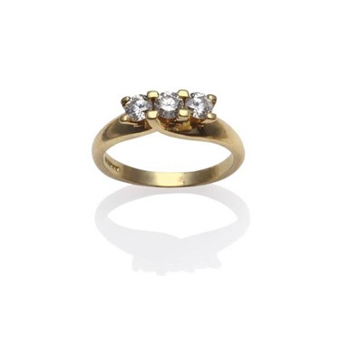 Lot 1114 - An 18 Carat Gold Diamond Three Stone Ring, three round brilliant cut diamonds in yellow claw...