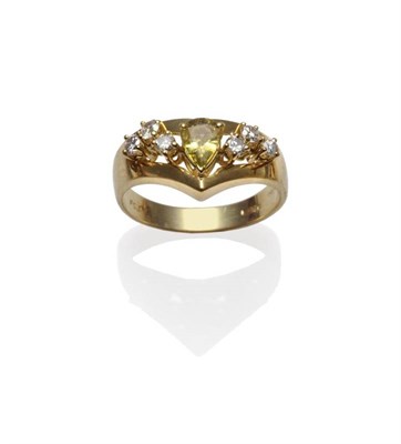 Lot 1118 - An 18 Carat Gold Yellow Sapphire and Diamond Ring, a pear cut yellow sapphire with three round...