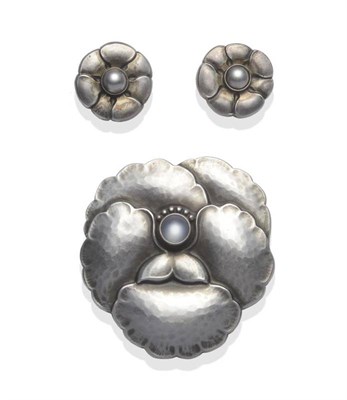 Lot 1131 - A Silver Brooch, by Georg Jensen, in the form of a flower, with a cabochon moonstone set centrally