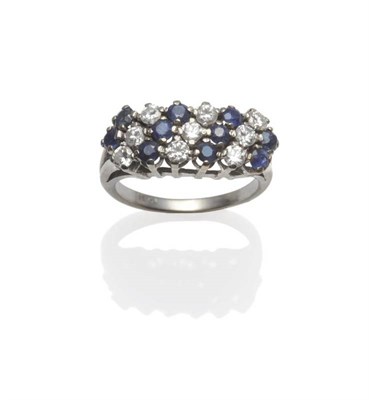 Lot 1155 - A Sapphire and Diamond Ring, diagonal rows of round cut sapphires and round brilliant cut...