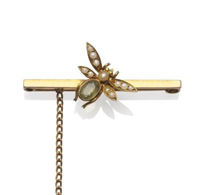 Lot 1160 - A Bug Brooch, circa 1900, the bug set with a peridot and seed pearls, on a bar, length 4.5cm