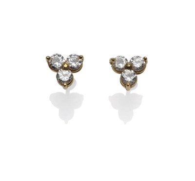 Lot 1175 - A Pair of Diamond Trio Cluster Earrings, each with three round brilliant cut diamonds in yellow...