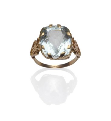 Lot 1176 - An Aquamarine Ring, a cushion cut aquamarine in a yellow claw setting, to yellow scroll...