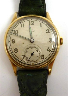 Lot 1180 - A 9ct Gold Wristwatch, signed Omega, 1941, lever movement numbered 9457124, silvered dial with...