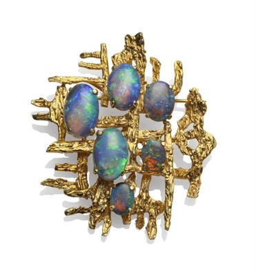 Lot 1187 - An Opal Triplet Brooch/Pendant, the textured asymmetric form overlaid with five opal triplets...