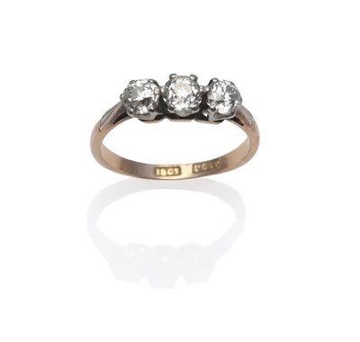 Lot 1206 - A Diamond Three Stone Ring, circa 1930, the old cut diamonds in white claw settings on white...