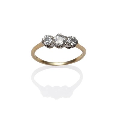 Lot 1208 - A Diamond Three Stone Ring, the graduated old cut diamonds in white claw settings on a yellow...