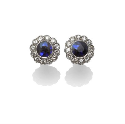 Lot 1222 - A Pair of Sapphire and Diamond Cluster Earrings, the round mixed cut sapphires within a border...