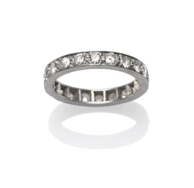 Lot 1225 - A Diamond Eternity Ring, the round brilliant cut diamonds in claw settings, within a flat sided...