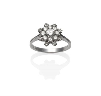 Lot 1240 - A Diamond Cluster Ring, a round brilliant cut diamond within a row of eight smaller, within a...