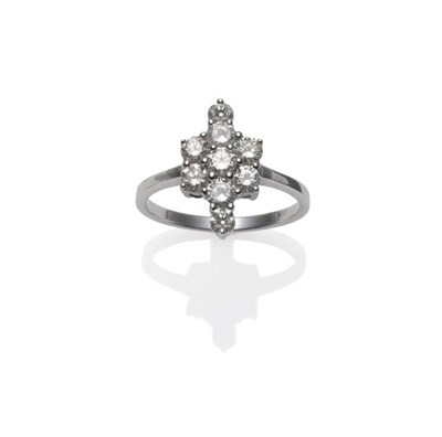 Lot 1246 - A Diamond Cluster Ring, seven round brilliant cut diamonds in a floral cluster, with a further...