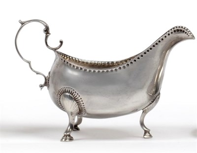 Lot 1041 - A George III Irish Silver Sauceboat, Matthew West, Dublin circa 1770,  with bead punched rim,...