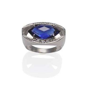 Lot 1114 - A Synthetic Sapphire and Diamond Ring, the faceted marquise shaped sapphire within a four claw...