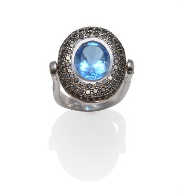 Lot 1116 - An 18 Carat White Gold Blue Topaz, Black and White Diamond Flip Ring, the oval cut topaz in a white