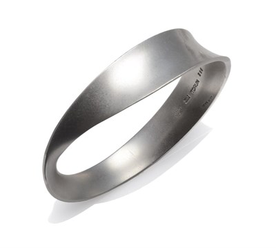 Lot 1123 - A Silver 'Mobius' Bangle, by Georg Jensen, the asymmetric form marked 'TORUN' and numbered 206