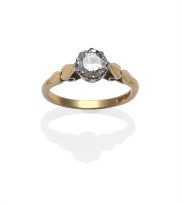Lot 1136 - A Diamond Solitaire Ring, a round brilliant cut diamond in a white claw setting, on a yellow...