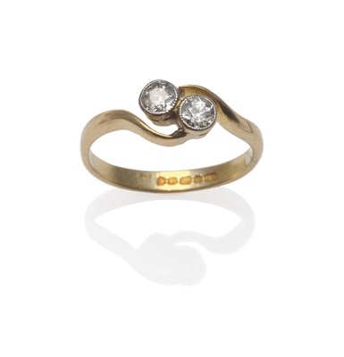 Lot 1139 - An 18 Carat Gold Diamond Two Stone Twist Ring, the old cut diamonds in white millegrain...
