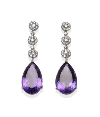 Lot 1155 - A Pair of 18 Carat White Gold Amethyst and Diamond Drop Earrings, three clusters of round brilliant