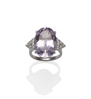 Lot 1158 - An 18 Carat White Gold Kunzite and Diamond Ring, the oval cut kunzite flanked by triangular...