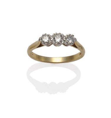 Lot 1178 - An 18 Carat Gold Diamond Three Stone Ring, the round brilliant cut diamonds in white claw...