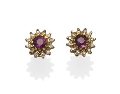Lot 1180 - A Pair of 9 Carat Gold Ruby and Diamond Cluster Earrings, the round mixed cut ruby within a...