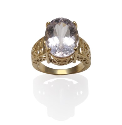 Lot 1182 - A 9 Carat Gold Kunzite Ring, the oval cut kunzite in a four claw setting, to decorative pierced...
