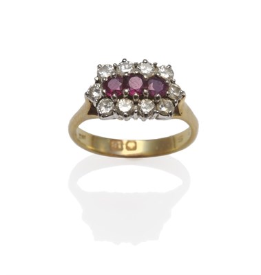Lot 1183 - A Ruby and Diamond Cluster Ring, three round rubies within an outer border of ten round...