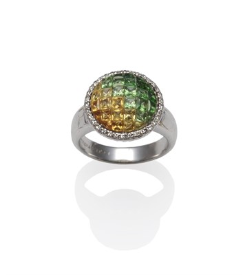 Lot 1219 - A Gemstone and Diamond Cluster Ring, square cut gemstones toning from green to yellow arranged in a